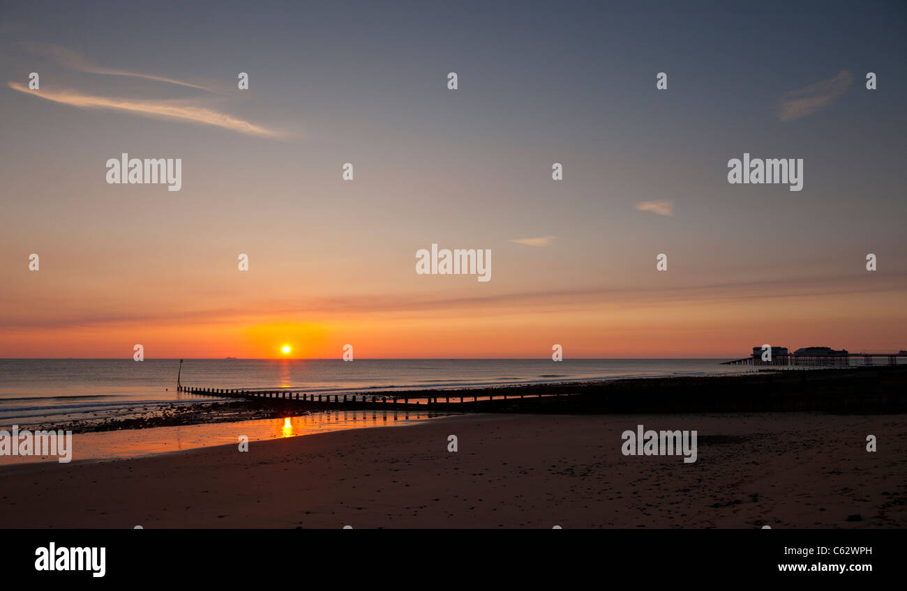 Cromer beach at Sunrise in Summer in Norfolk England Stock Photo