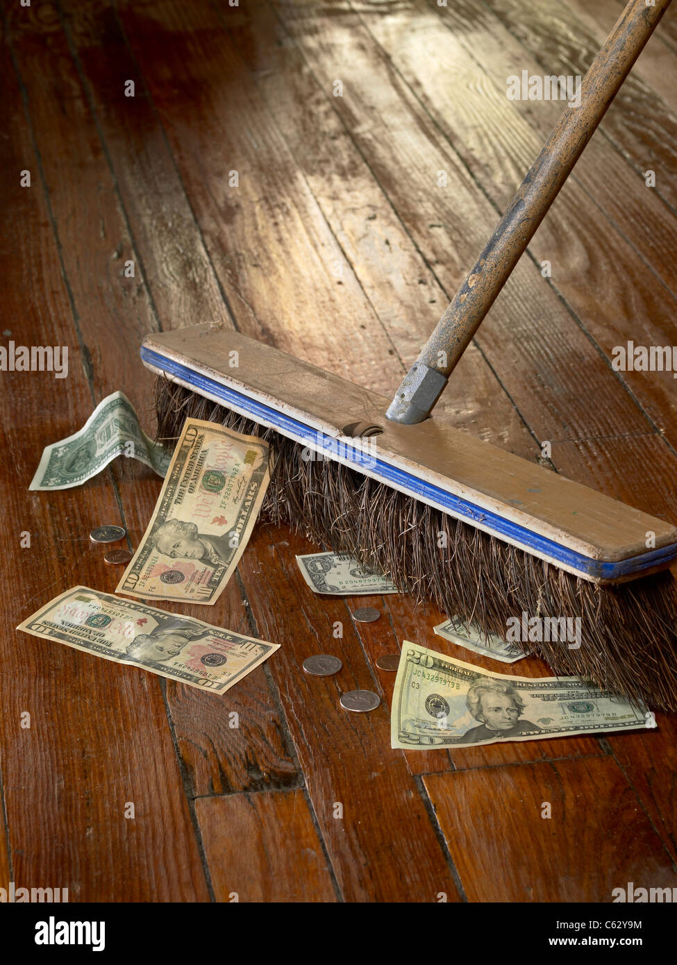 Broom Sweeping Up Money Stock Photo