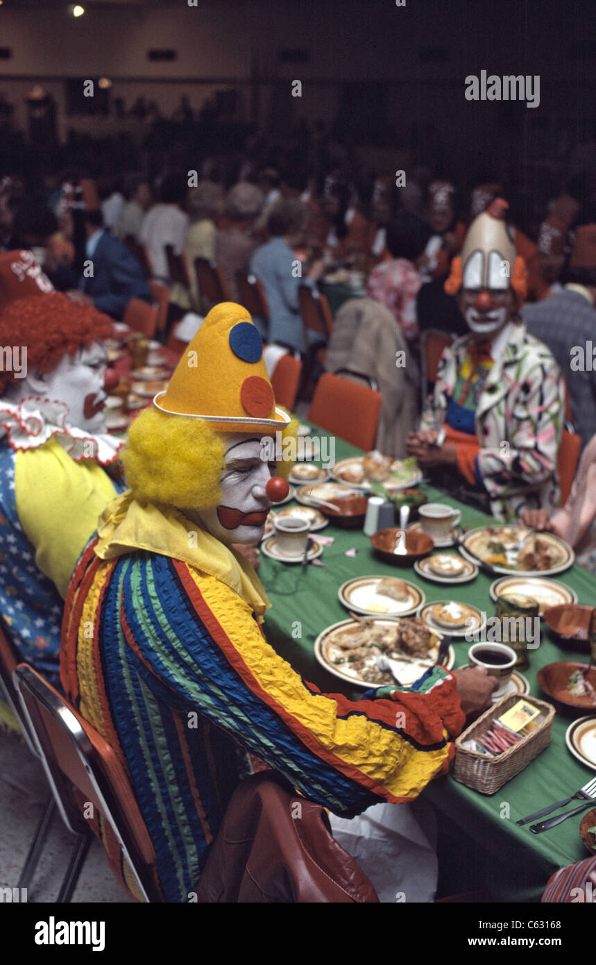 Shriners event with clowns in full make-up and costume eating Stock Photo
