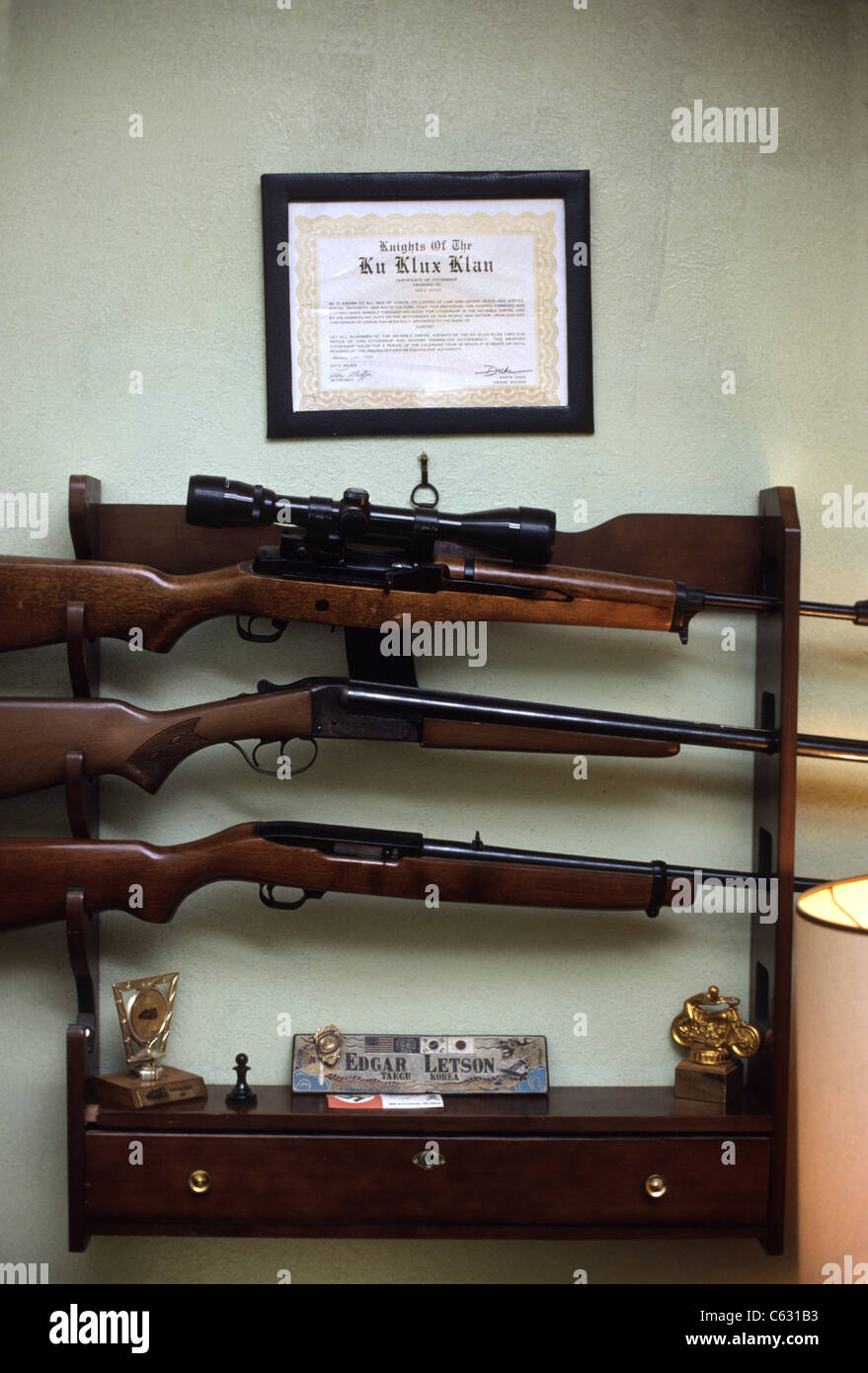 Klu Klux Klan wall certificate hanging above a gun rack Stock Photo - Alamy