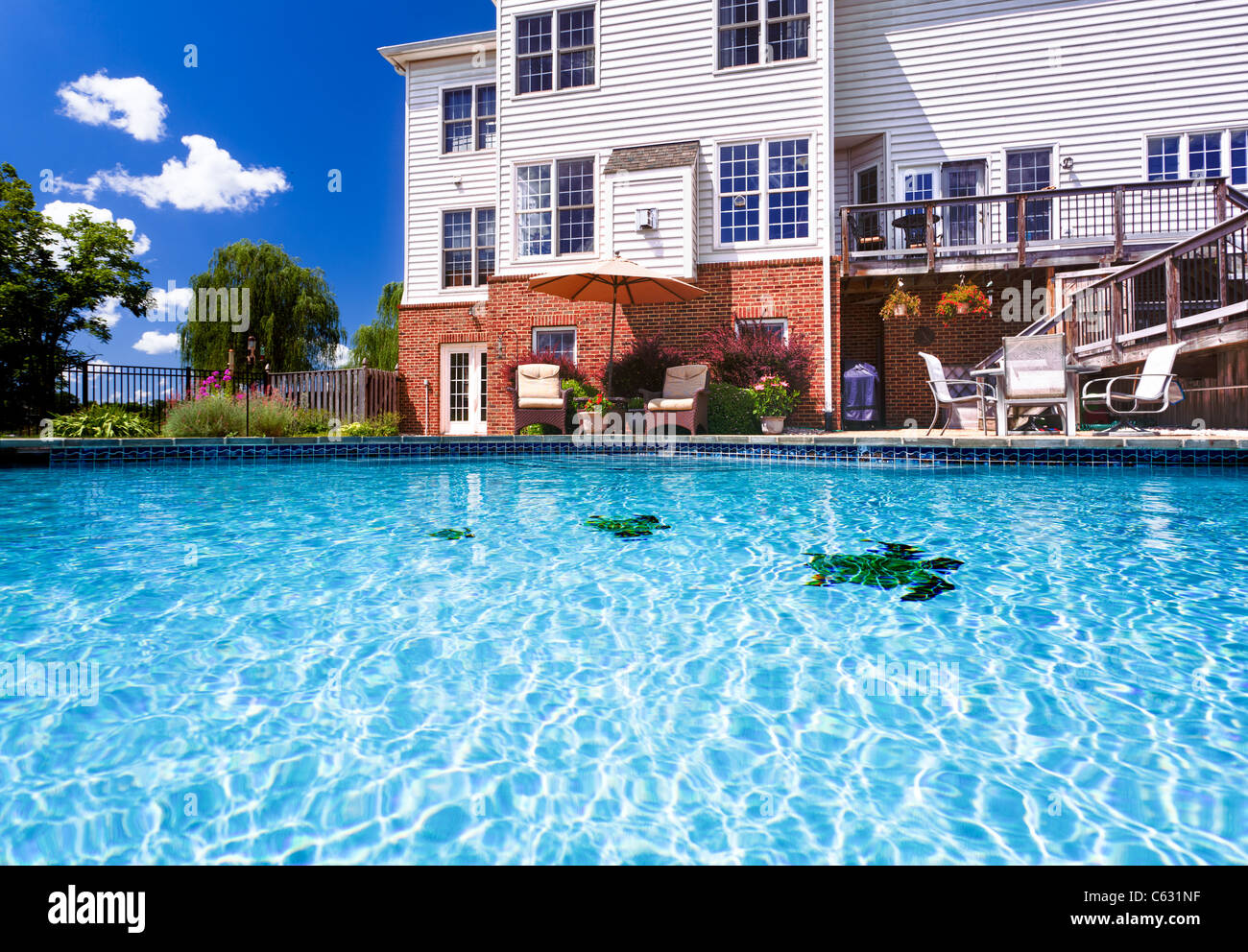 Swimming pool in the backyard garden of a large detached house Stock Photo