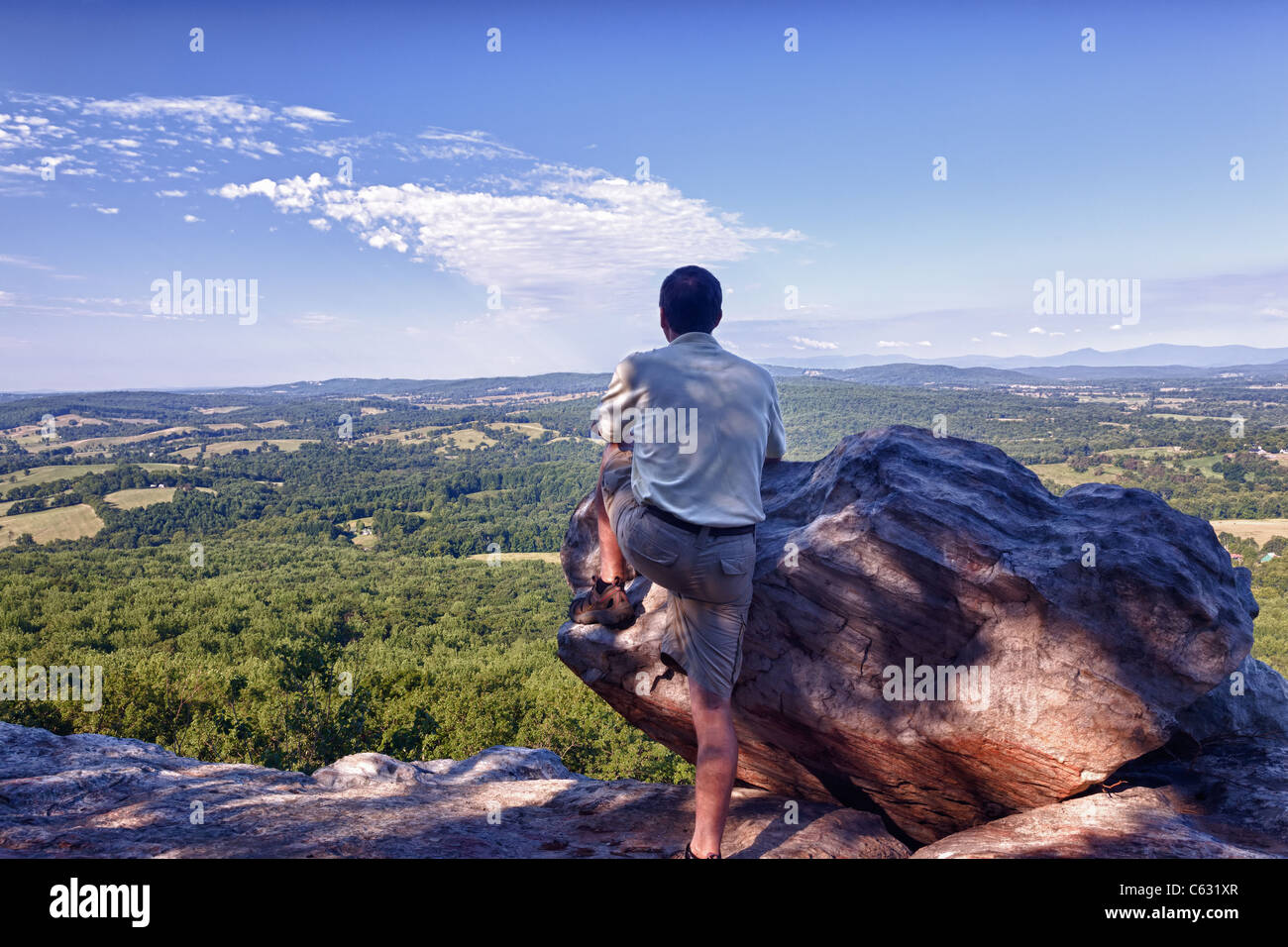 Retired hiker on top of Bull Mountain in Virginia overlooking the valley towards the Blue Ridge and Shenandoah Stock Photo
