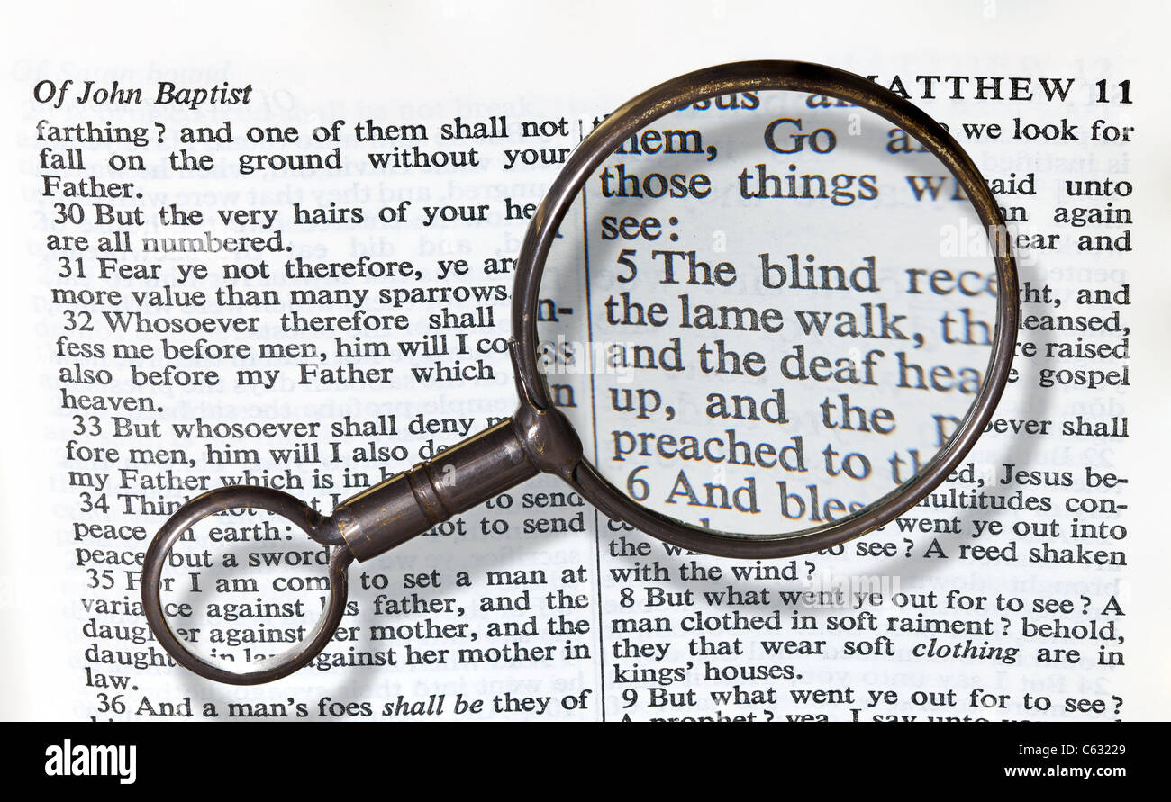 Antique brass magnifying glass over the top of an Authorized King James