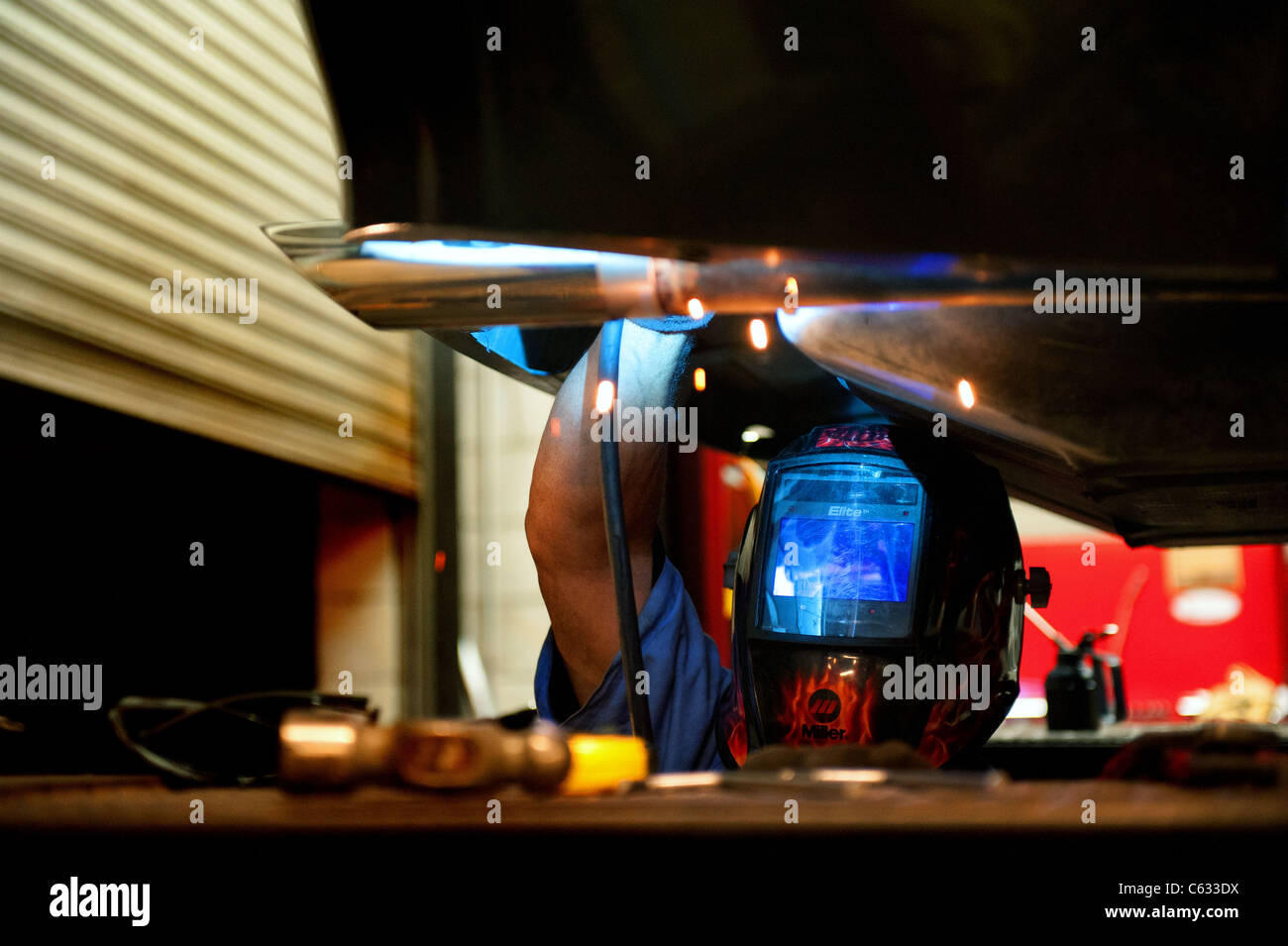 Mechanic soldering a muffler Stock Photo Alamy