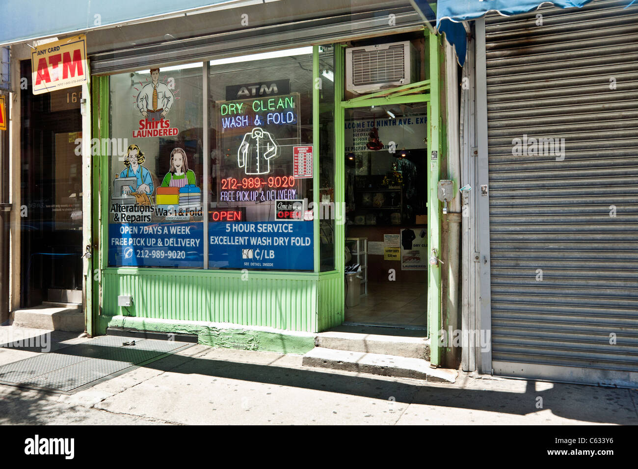 colorful dry cleaning shop with delightful retro illustrations & a white neon shirt sign in window Chelsea neighborhood New York Stock Photo