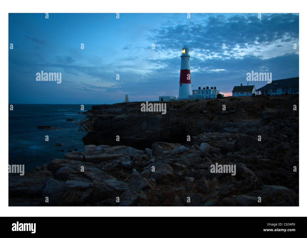 A photograph of Portland Lighthouse at Portland Bill in the UK, taken at sunset. Stock Photo