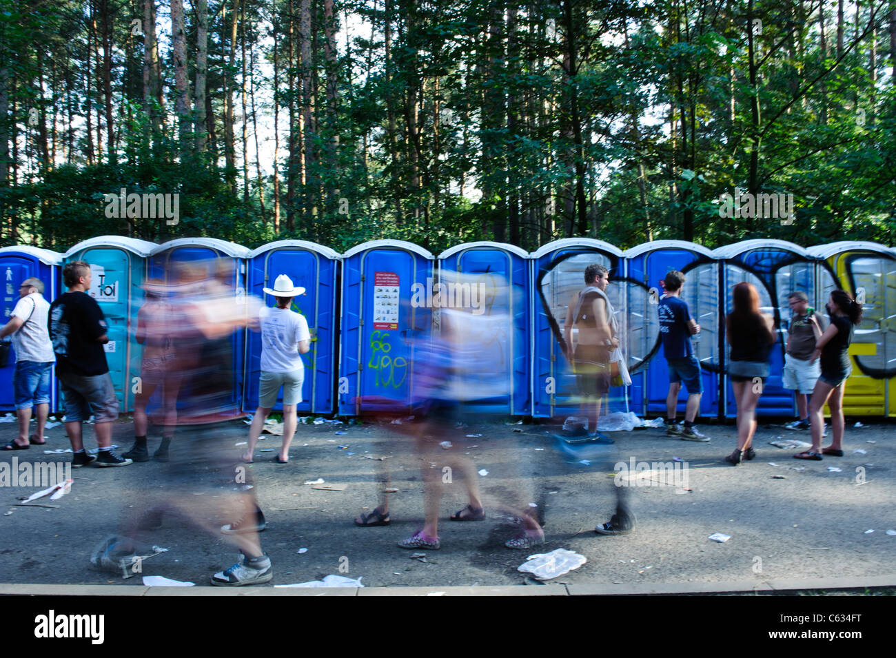 People waiting by the portable toilets at the Przystanek Woodstock