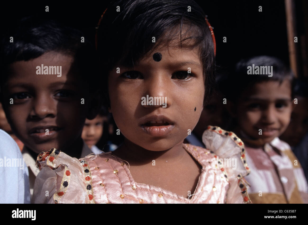 Ethnic Tamil schoolchildren crowd around a camera in Jaffna City, Sri Lanka. The LTTE has been fighting for a separate state. Stock Photo