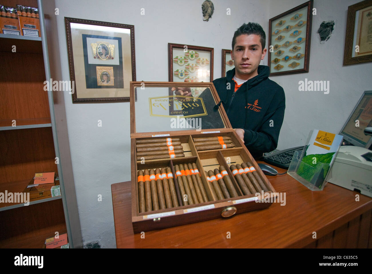 Cigar seller shows fine cigar selection of El Sitio, La Palma, Canary islands, Europe Stock Photo