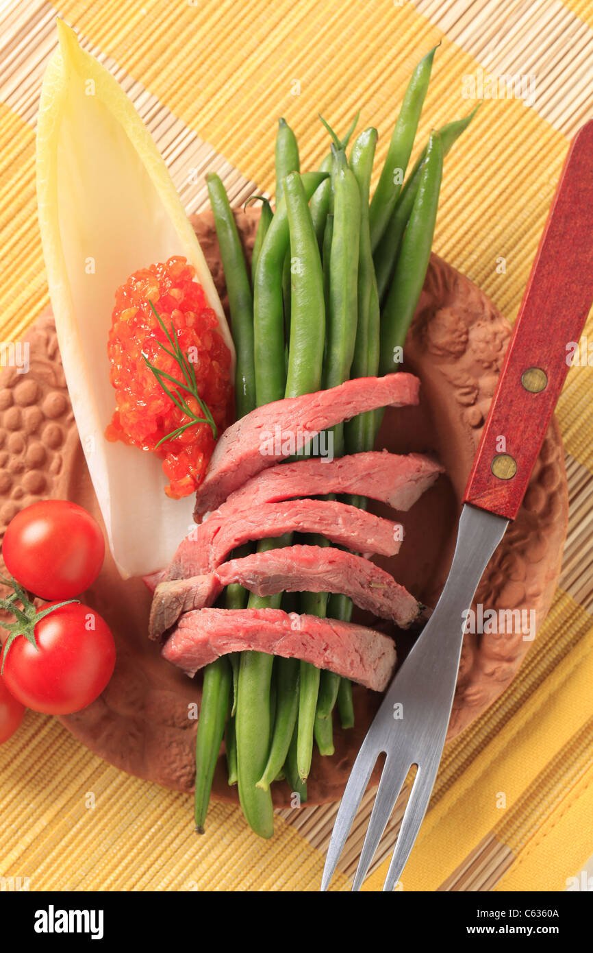 Strips of roast beef and fresh vegetables Stock Photo