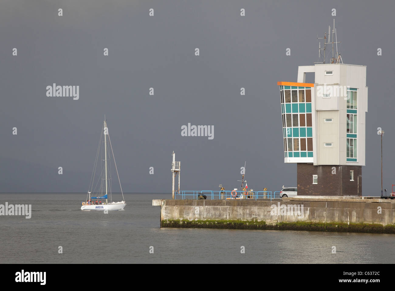 Yacht sailing past the Clydeport Control Tower at Greenock Ocean Terminal on the River Clyde, Inverclyde, Scotland, UK Stock Photo