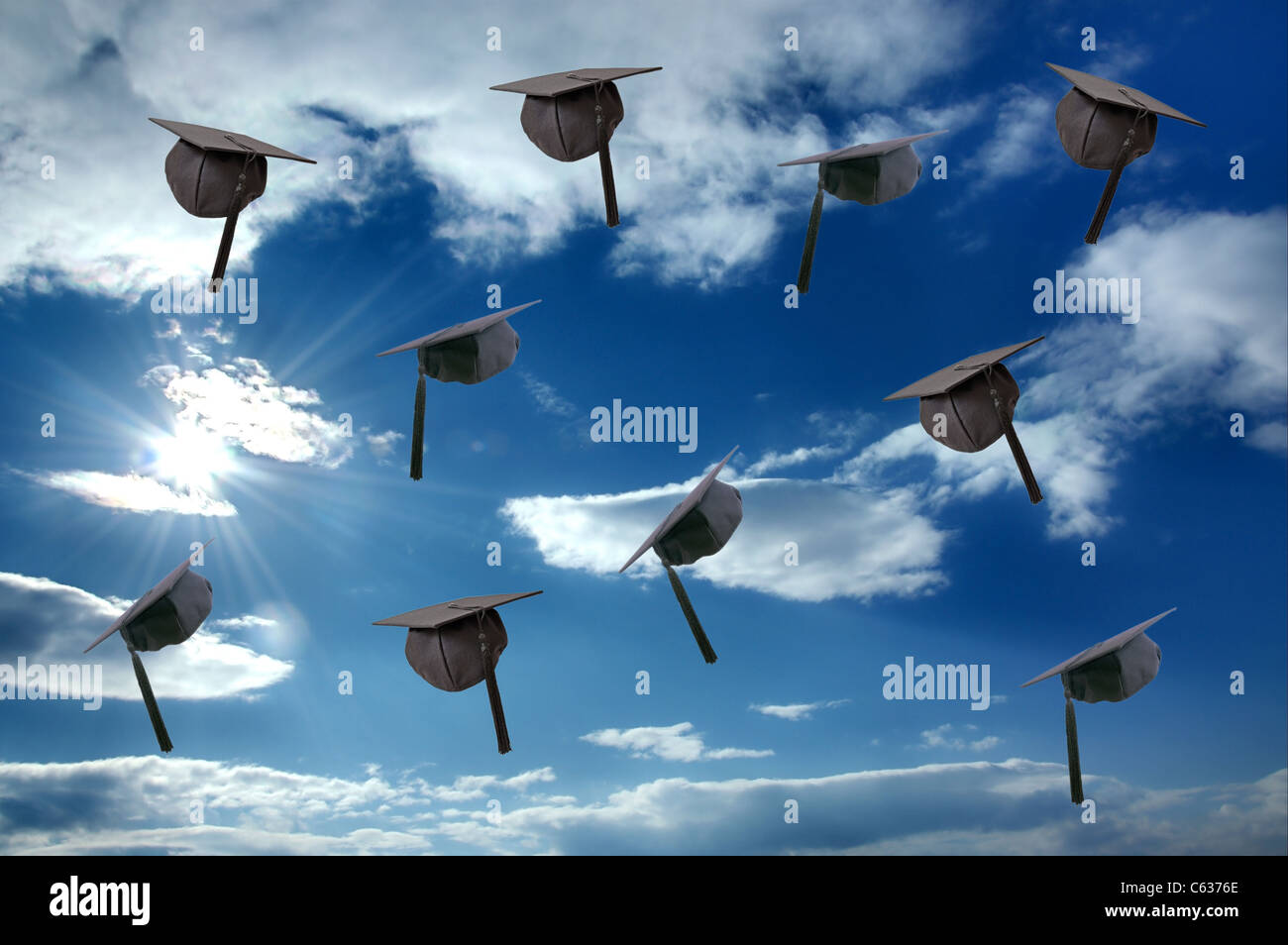 Student graduation hat over sunny sky Stock Photo