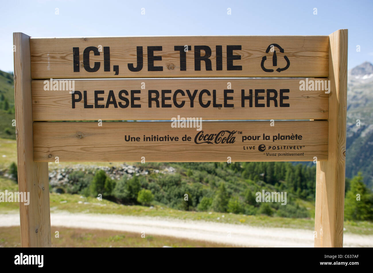 New bilingual wooden sign at recycling bins at top of cable car in the French Alps near Chamonix Mont Blanc. Stock Photo