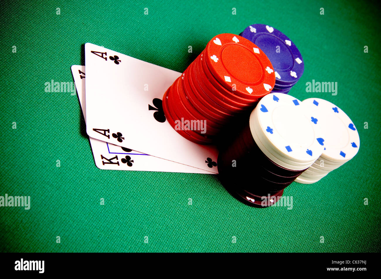 Playing cards and gambling chips on green background Stock Photo