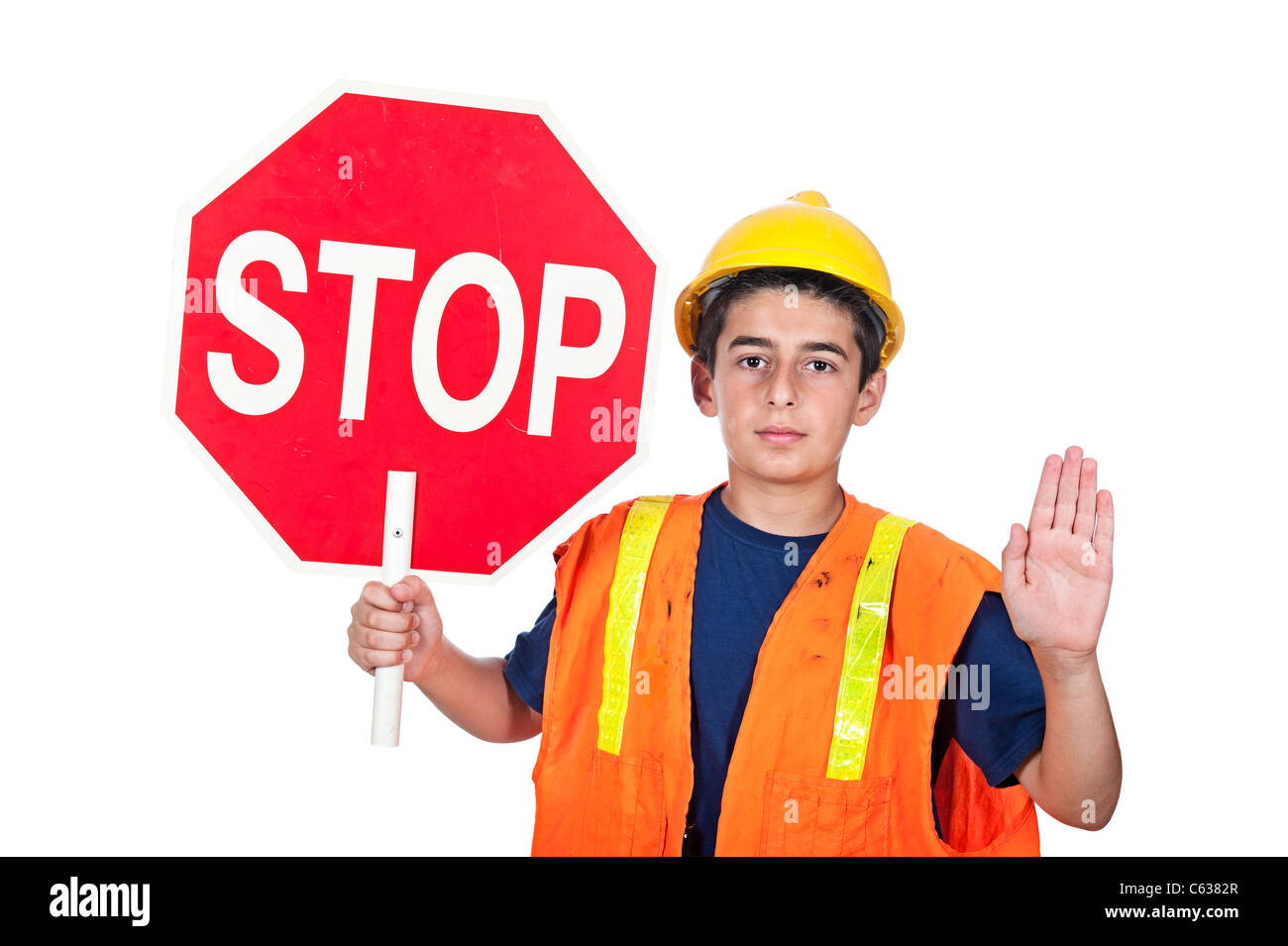 A young man holds up a stop sign together with a hand signal to stop. Stock Photo