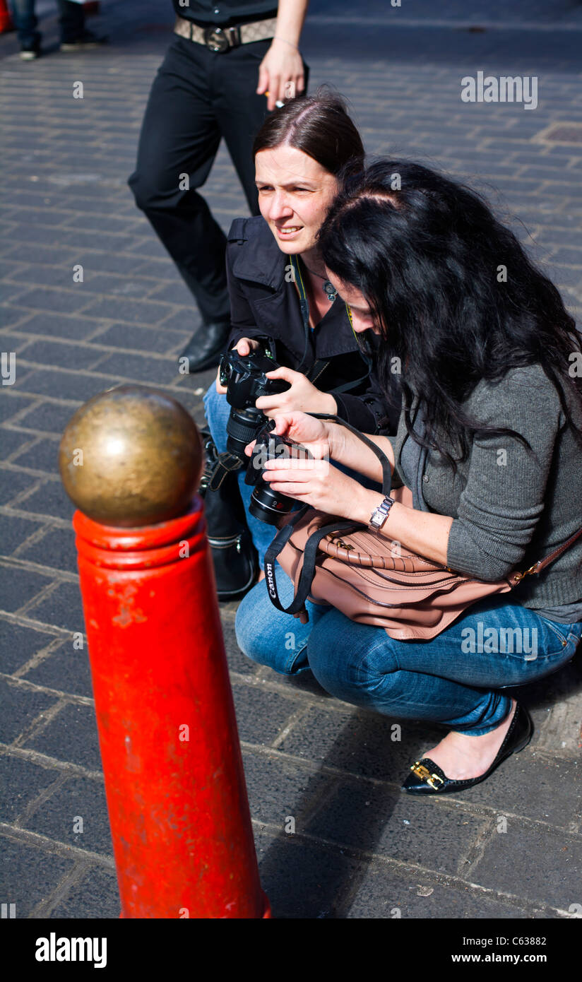 Two serious female photographers compare shots, China town, London, UK, Europe Stock Photo