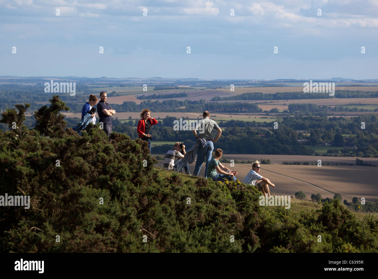 Walkers resting on top of Milk Hill Wiltshire Stock Photo Alamy