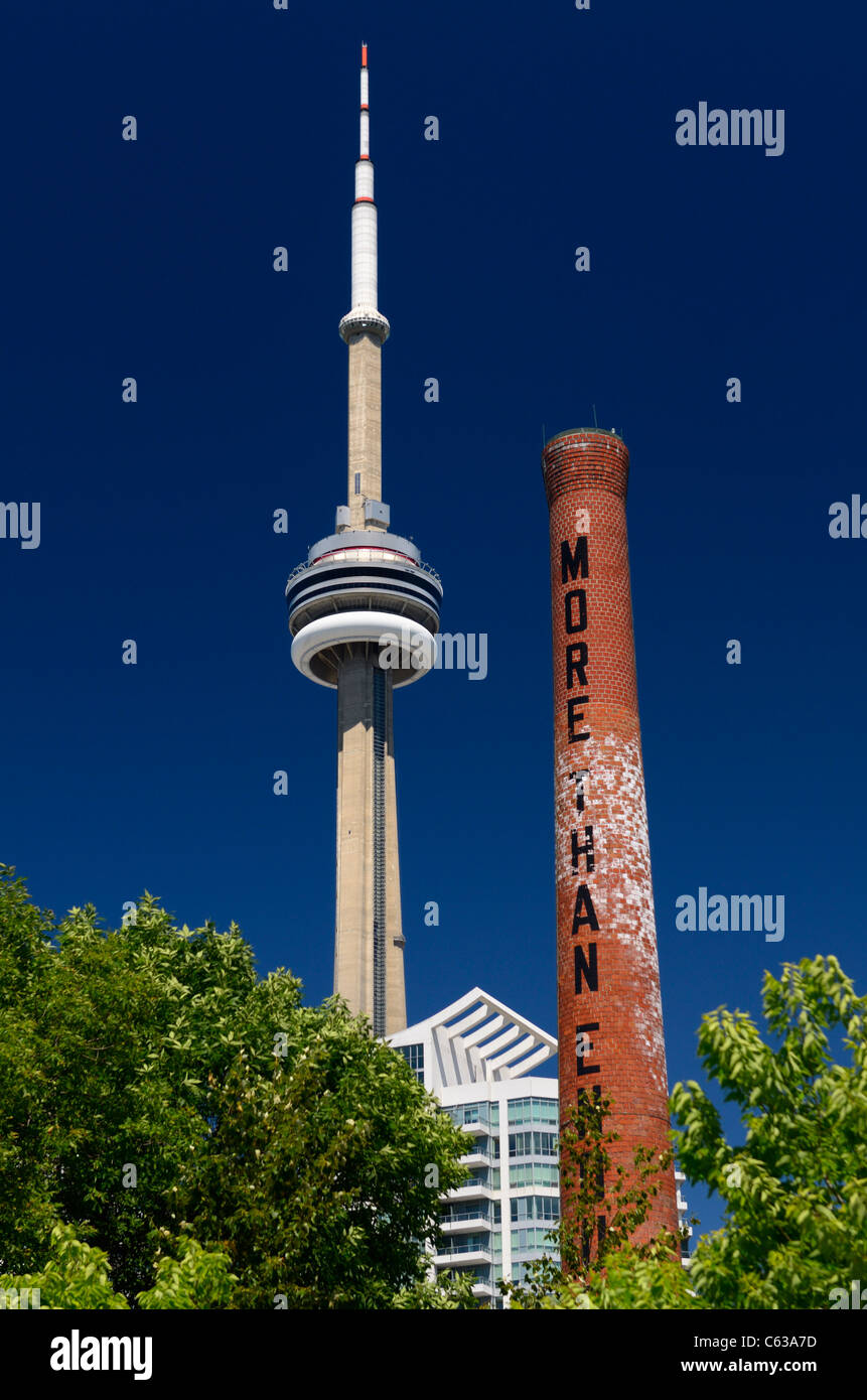 Power Plant Art Gallery smoke stack and CN Tower in Toronto against blue sky Stock Photo