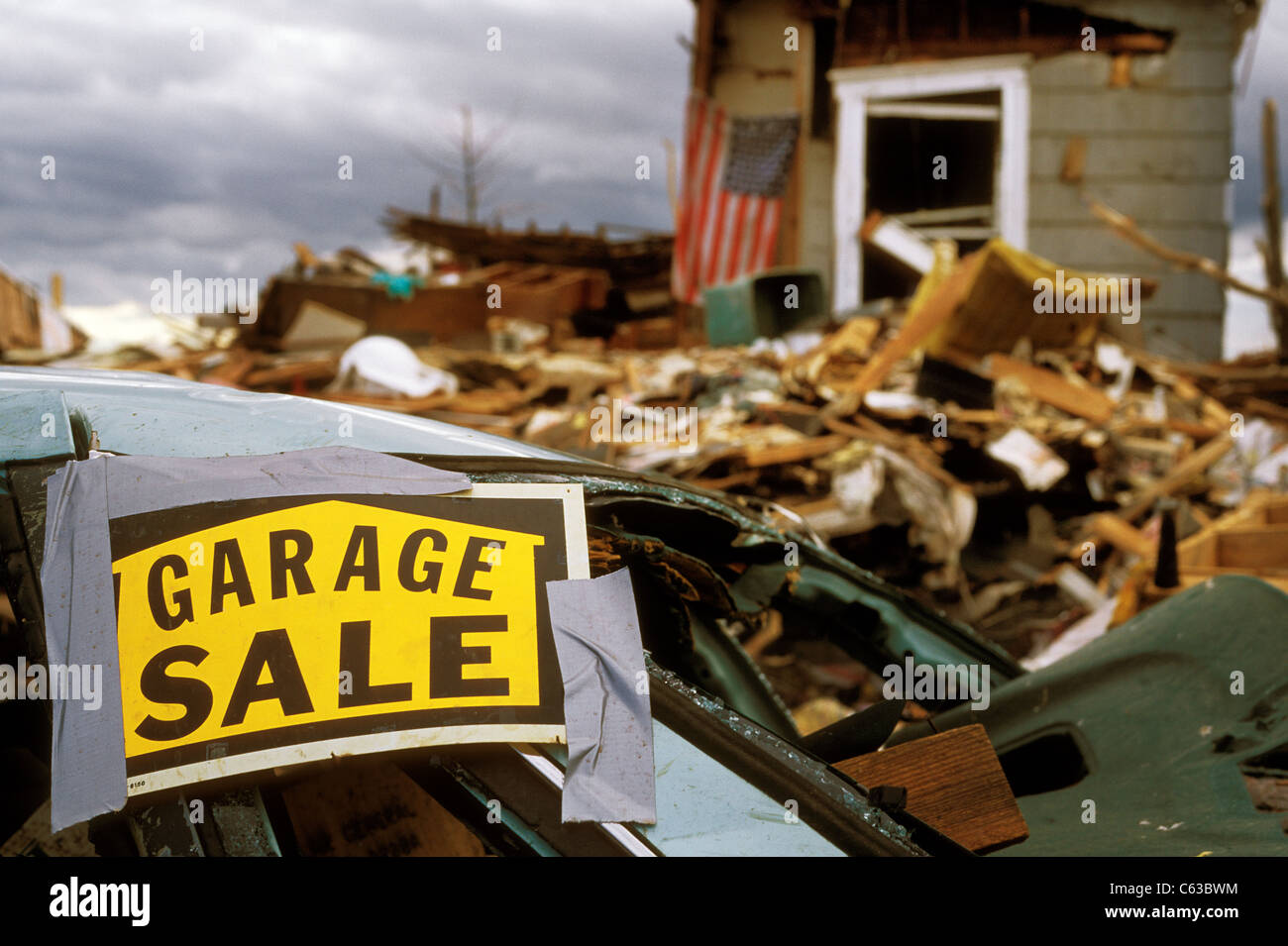 A garage sale sign stuck to a car after a tornado in Joplin, Missouri