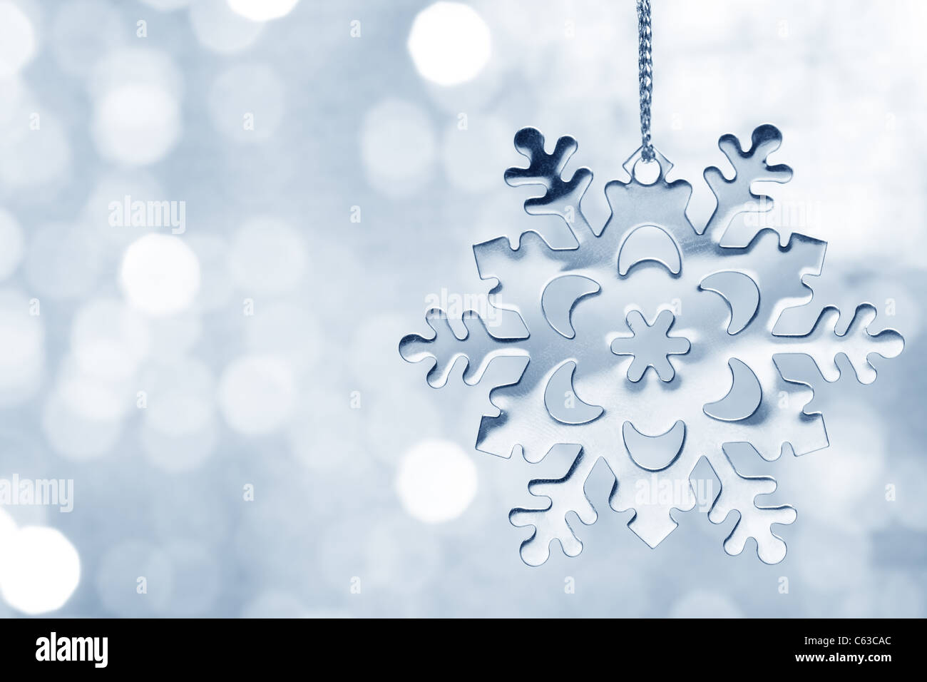 Silver blue snowflake against shimmering background Stock Photo