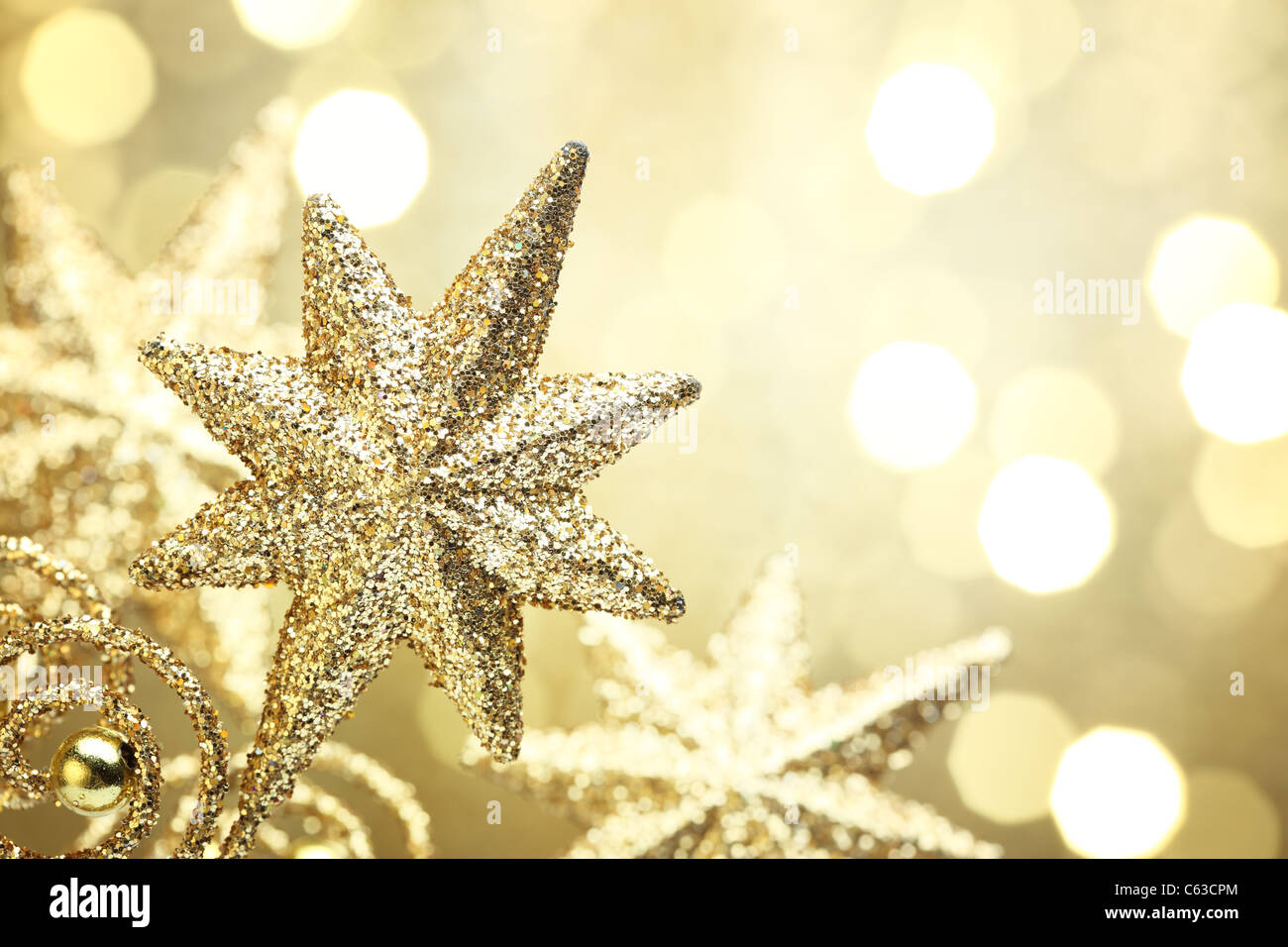 Closeup of golden star on abstract golden light background. Stock Photo