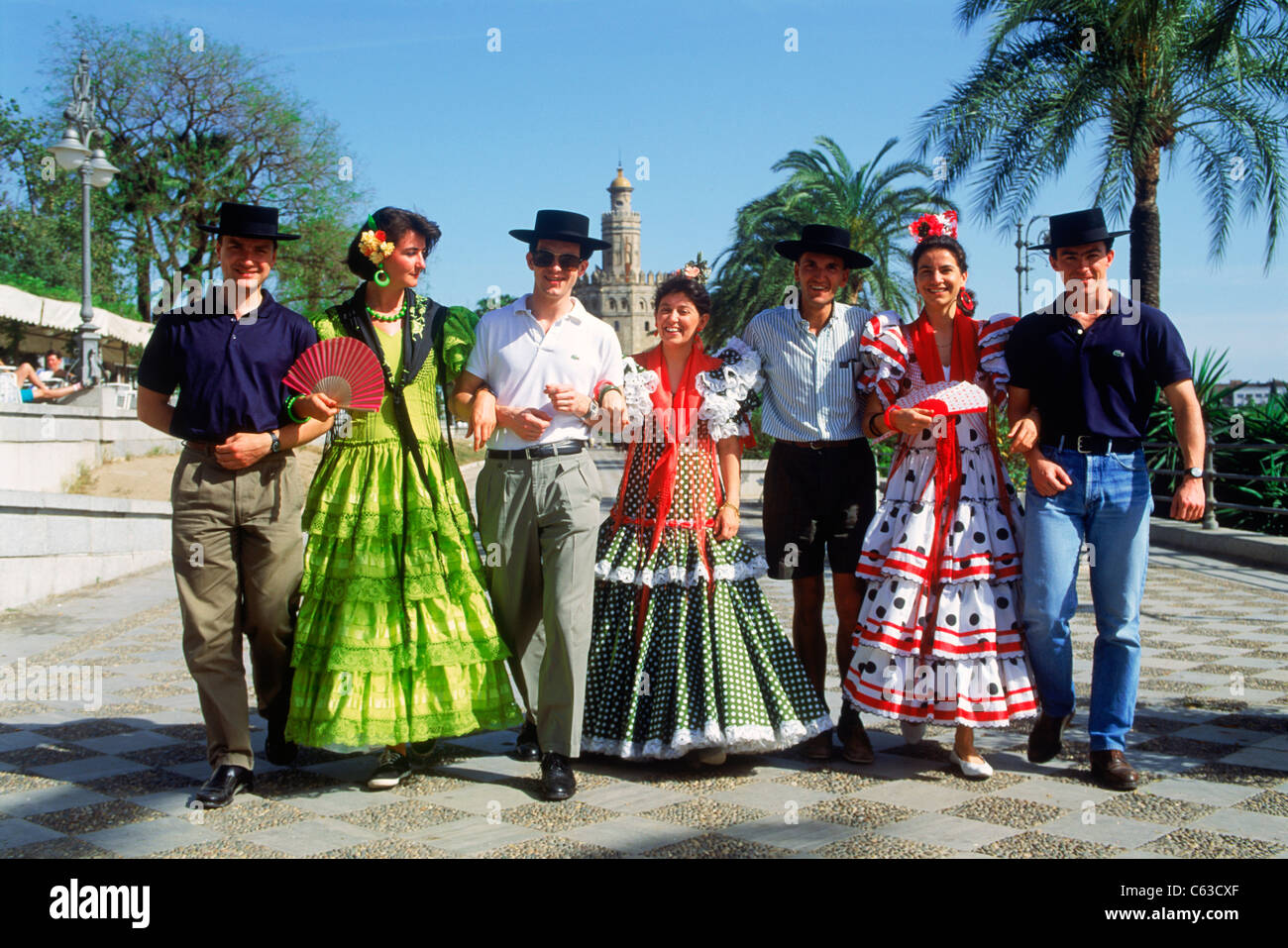 Young men and women with traditional colorful costumes during "Feria De  Sevilla" festival in Seville (Sevilla), Spain Stock Photo - Alamy