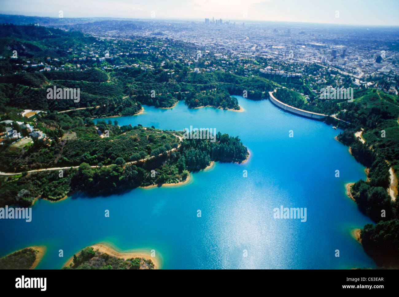 Aerial view of reservoir  in Hollywood Hills along base of Santa Monica Mountains with downtown Los Angeles Civic Center Stock Photo