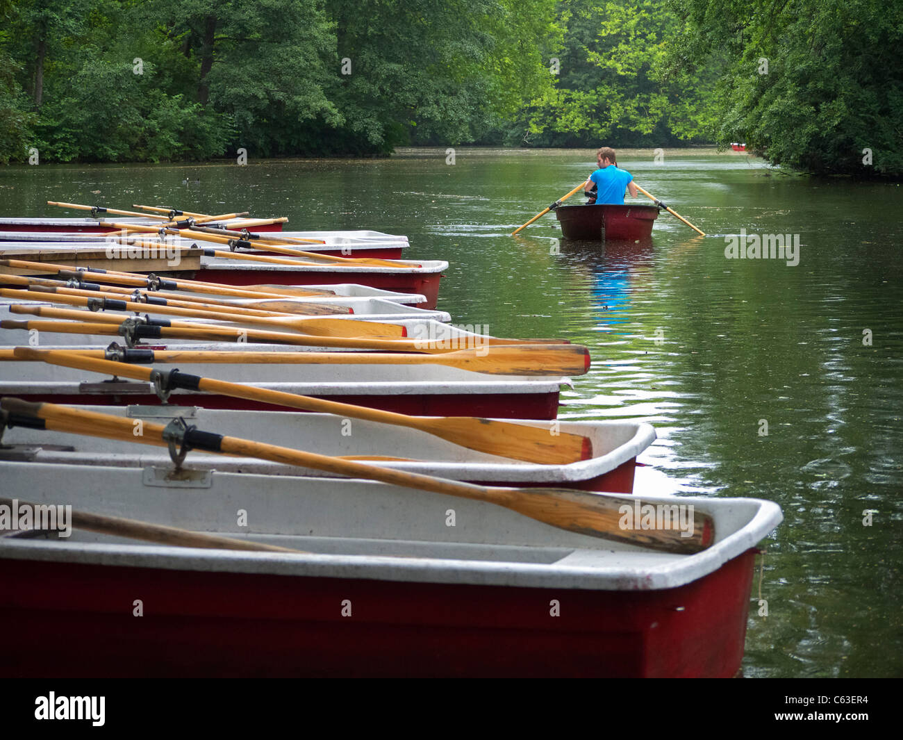 People rowing boats in lake at Tiergarten park in Berlin Germany Stock Photo