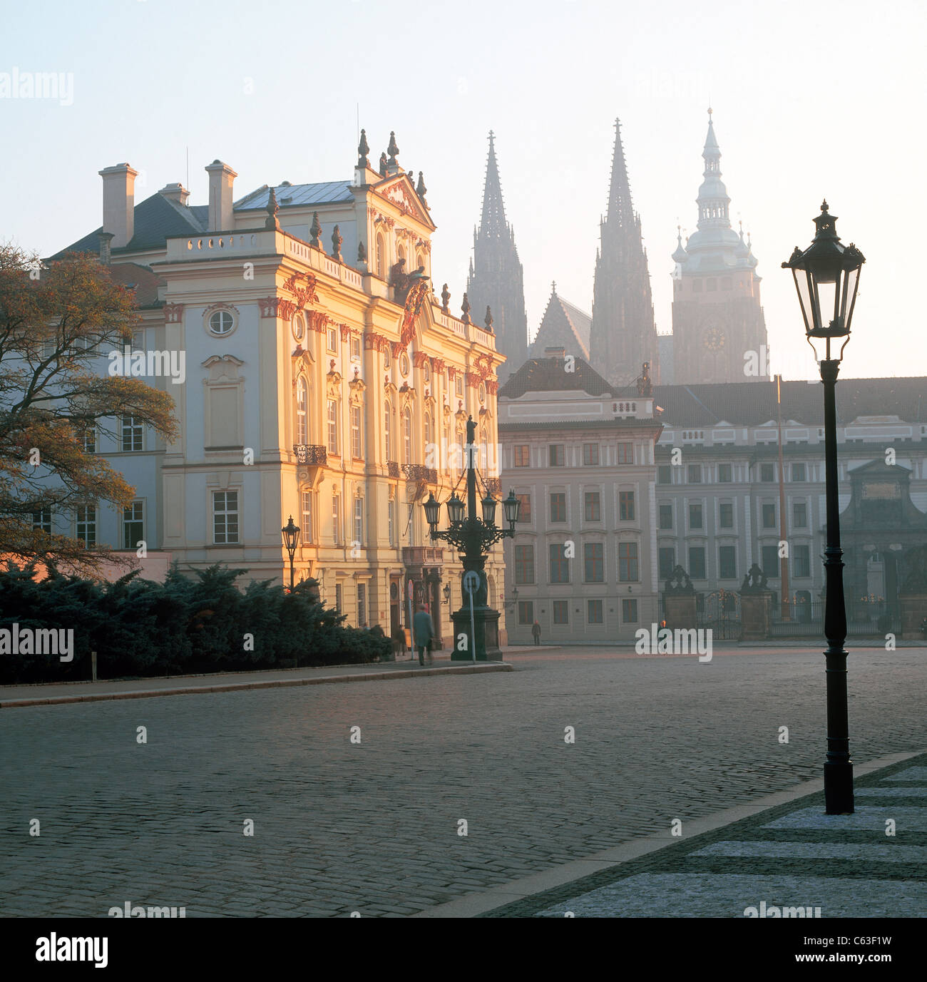 St Vitus Cathedral and Hradcany Castle with cobblestones and old street lamps in sunrise light Stock Photo