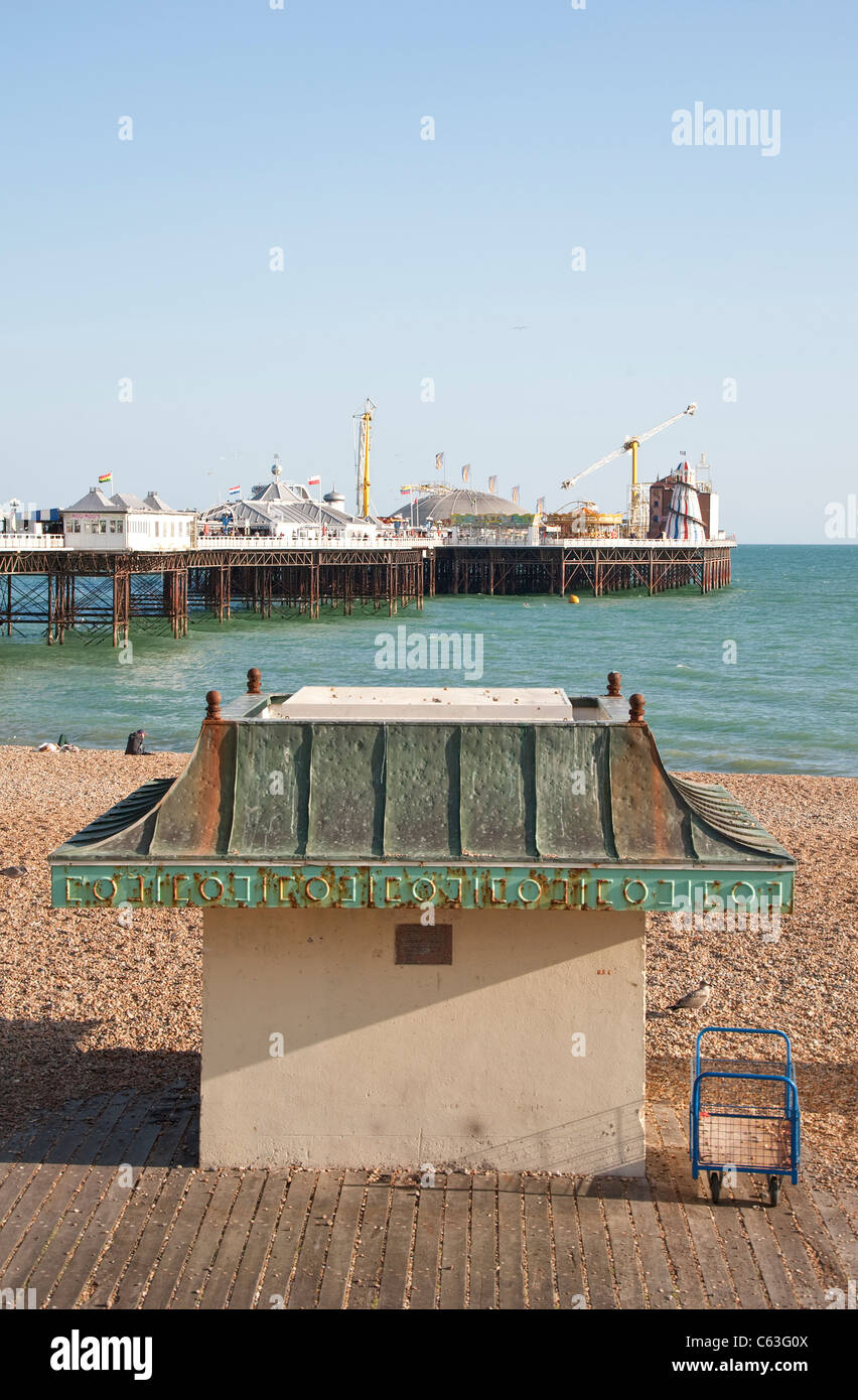 Brighton beach shelter and Palace Pier Stock Photo