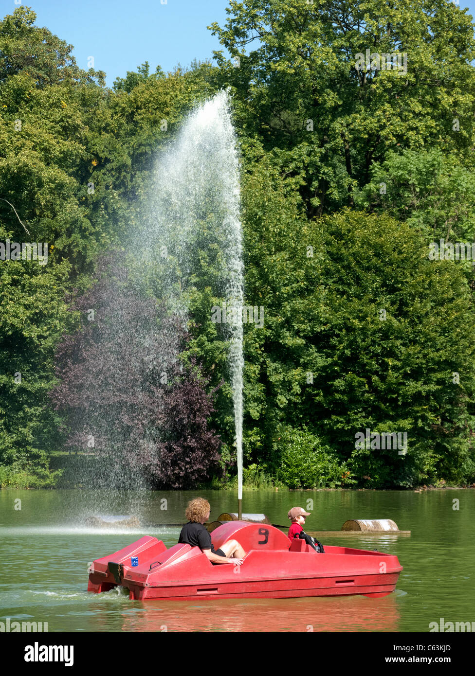 People relaxing in Volksgarten park  in Cologne Germany Stock Photo