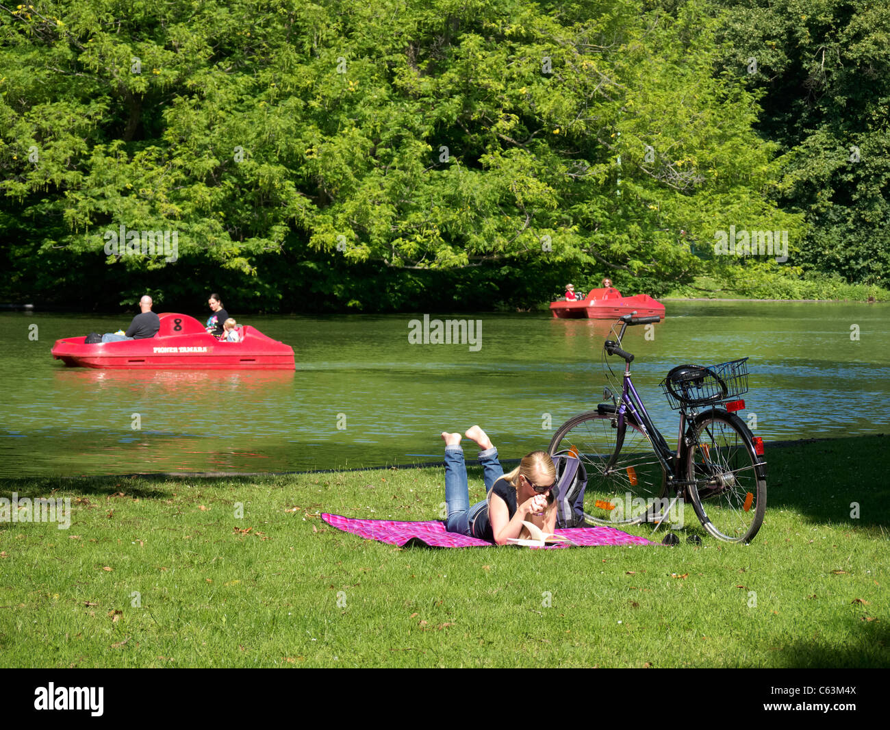 People relaxing in Volksgarten park  in Cologne Germany Stock Photo