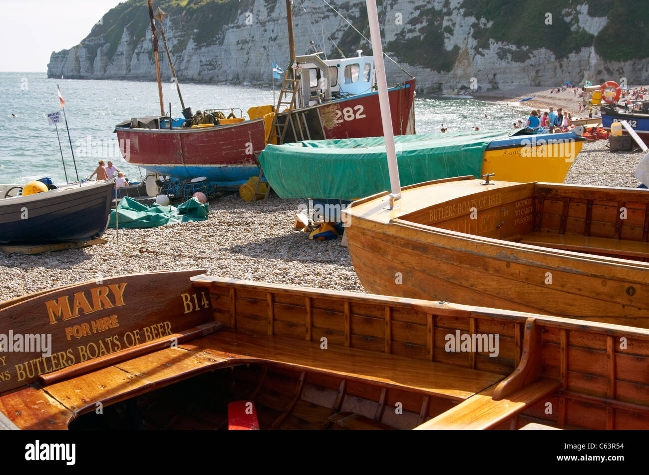 Fishing boats and selfdrive hire boats on the shingle beach at Beer