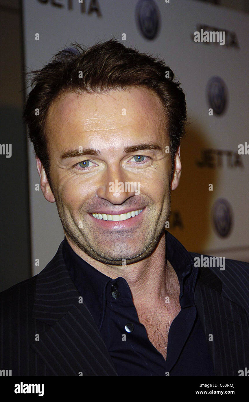 Julian McMahon poses for photographers, at the launch of the 2005 Volkswagen Jetta at The Lot, Los Angeles, CA January 05, 2005. Photo by: Michael Germana/Everett Collection Stock Photo