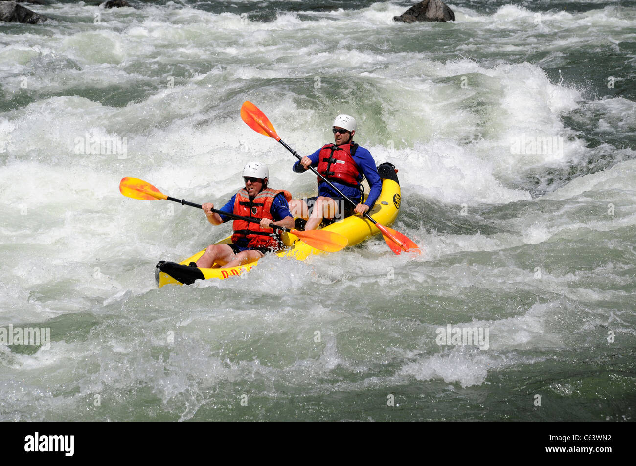 Two man inflatable kayak with O.A.R.S. in whitewater at Big Mallard Rapids on Main Salmon River in Idaho Stock Photo