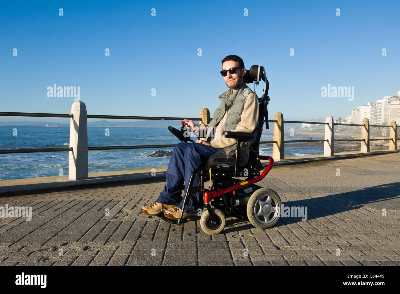 Person in a wheelchair enjoying an outing at Beach Road in Cape Town