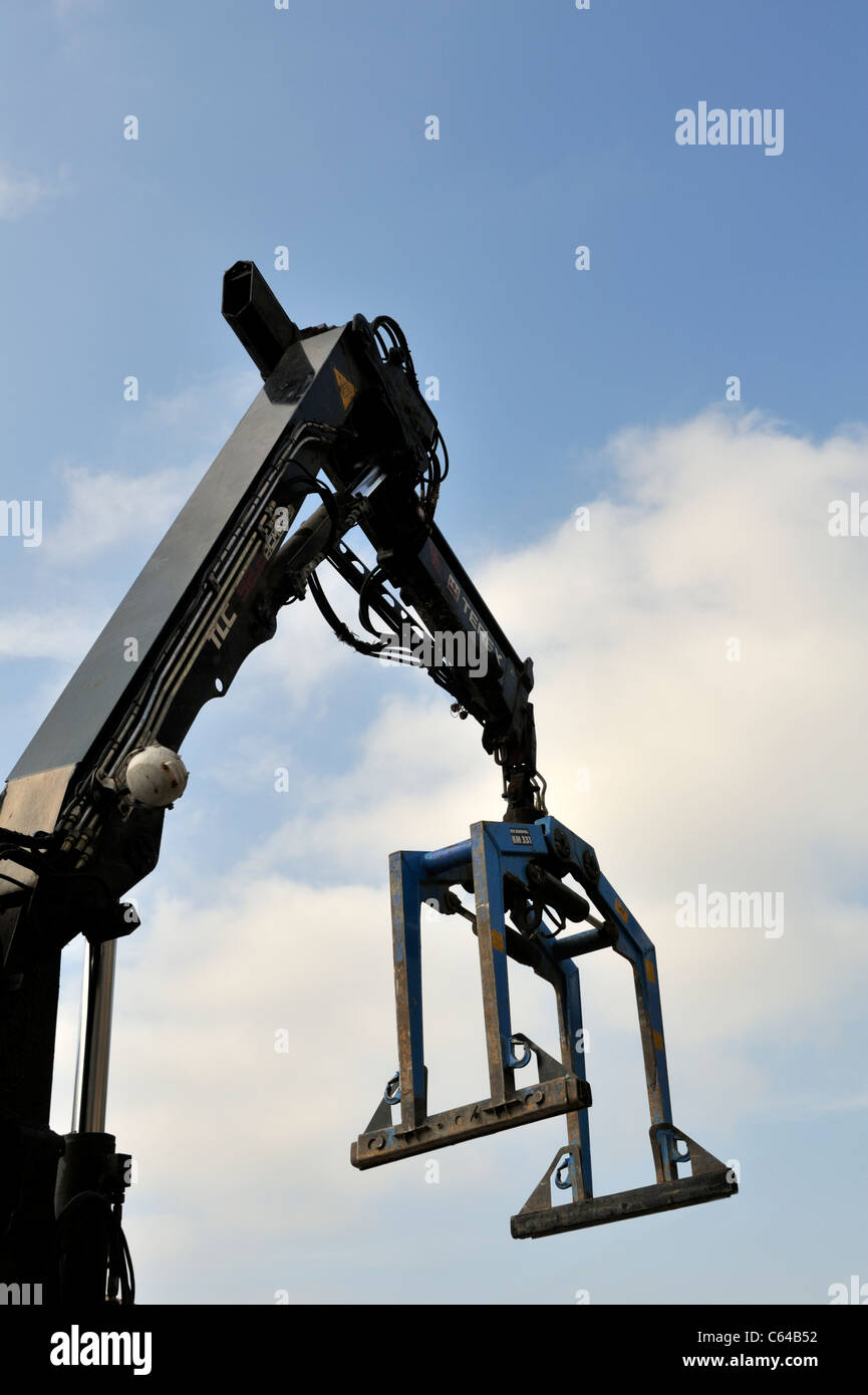 Crane with brick-grab for lifting pallets of bricks or blocks Stock Photo