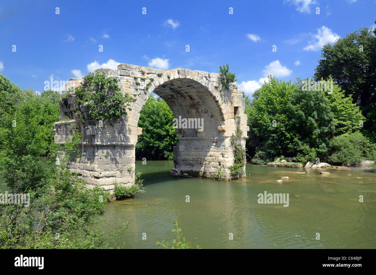 Roman Bridge, the Pont Ambroix, at Ambrussum (painted by Gustave Courbet) over River Vidourie on Roman Road Via Domitia, near Lunel, Hérault, France Stock Photo