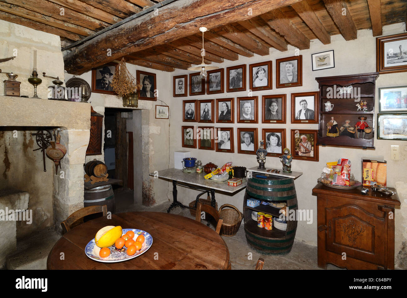 Old or Rustic Kitchen of Troglodyte Farmhouse, House or Dwelling, Mas de la Pyramide, with Family Portraits, nr Saint-Rémy-de-Provence Provence France Stock Photo