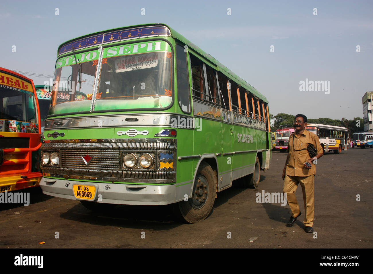 Conductor boards private Express bus departing from bus station in Thrissur Kerala India Stock Photo