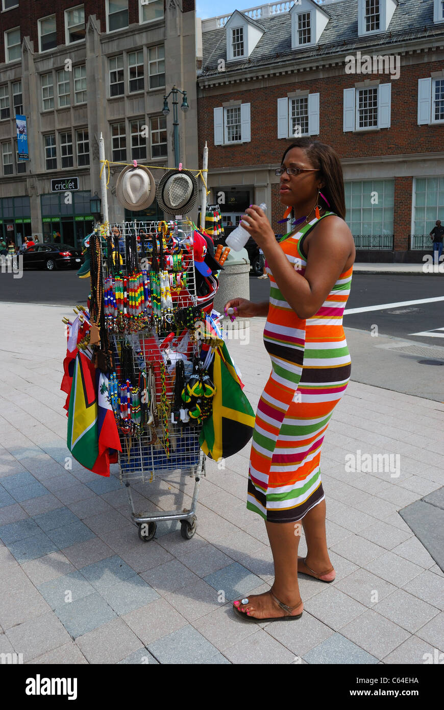 Vendor selling memorabilia flags, buttons, and stickers of Caribbean