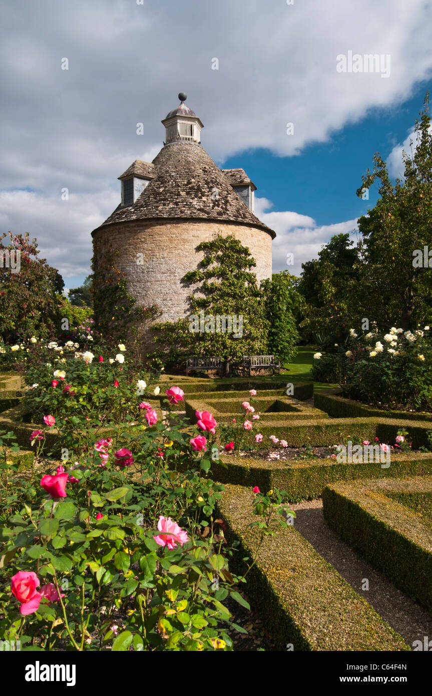 The Pigeon House, built in 1685, stands amongst the roses and box hedges of the Parterre at Rousham House, Oxfordshire, England Stock Photo