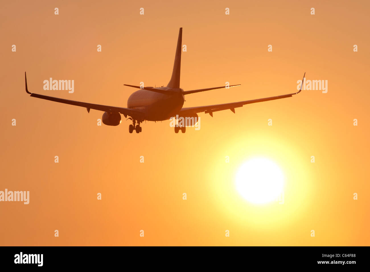 Airplane with jet engines with sunset in the background Stock Photo