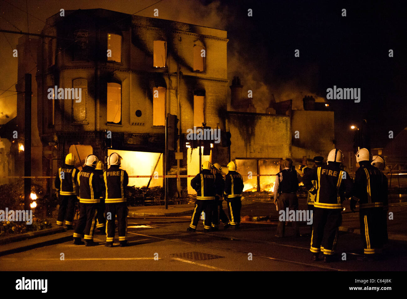 Firemen tackle the blaze at Reeves set by rioters during the 2011 London Riots. Stock Photo