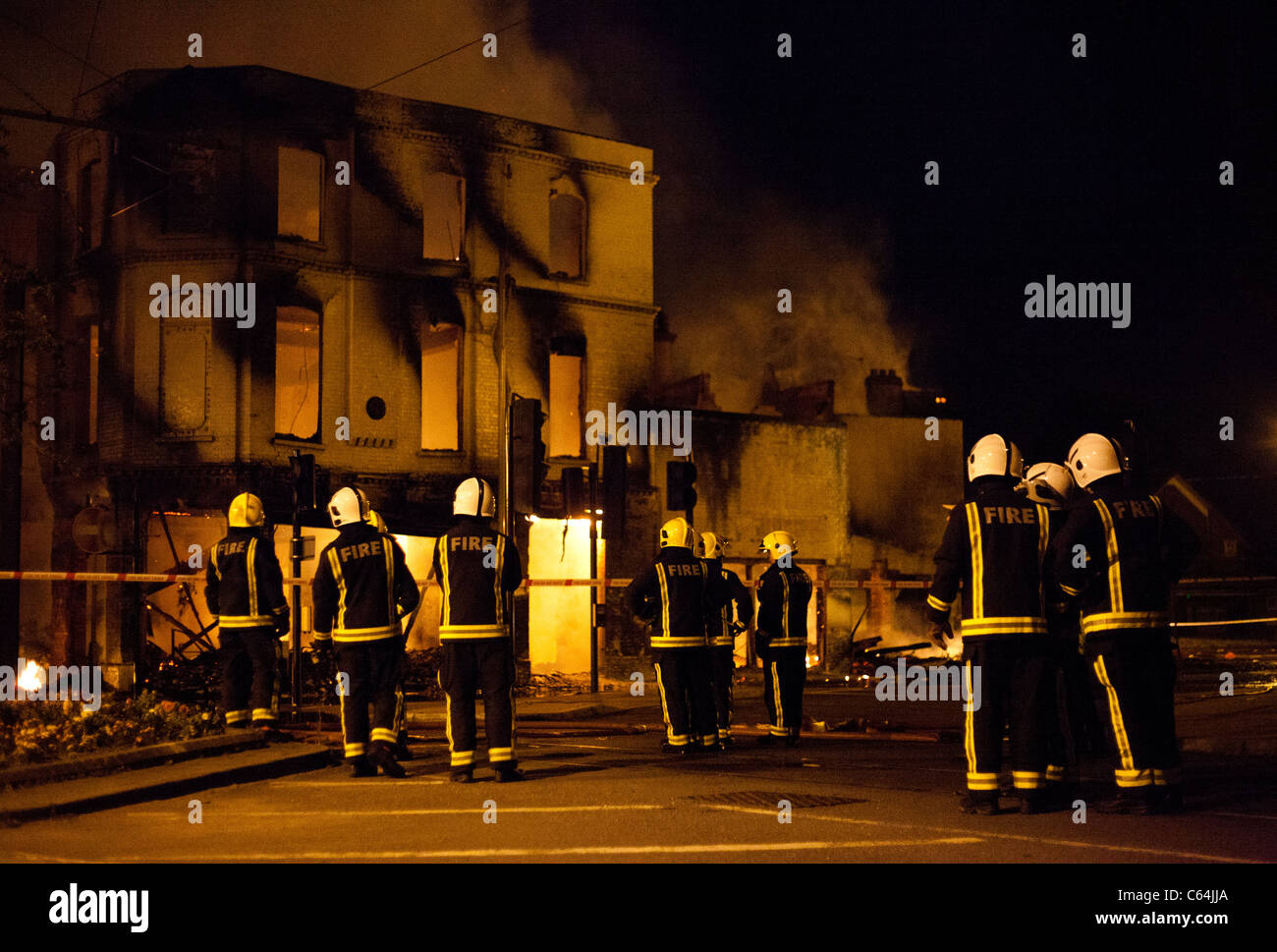 Firemen tackle the blaze at Reeves set by rioters during the 2011 London Riots. Stock Photo