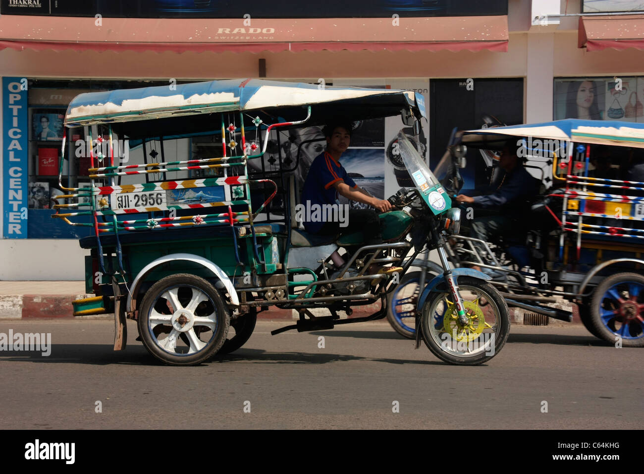 Laotian Jumbo tricycle passenger rickshaws in Vientiane, Laos Stock Photo -  Alamy