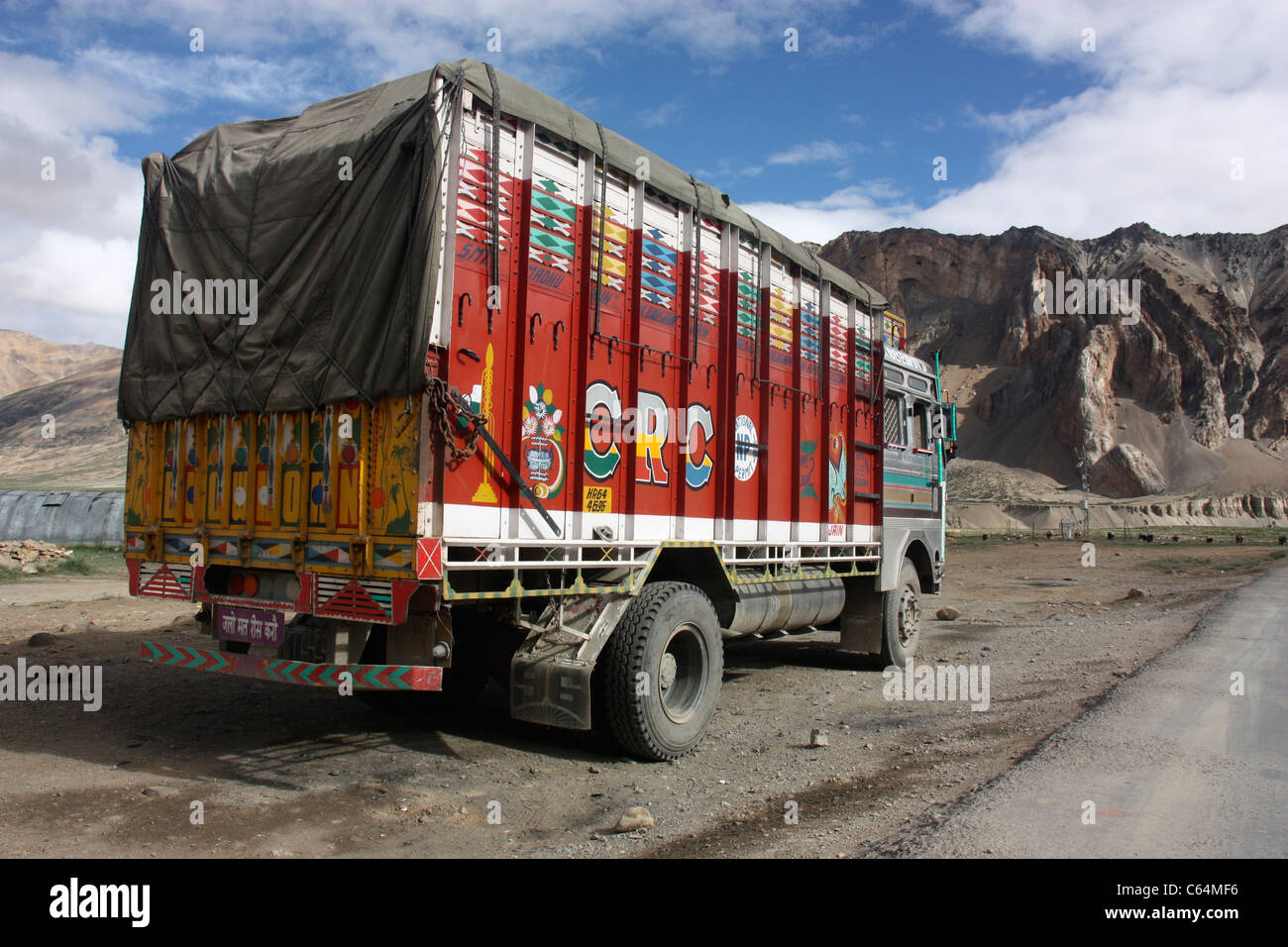 Decorated Tata goods carrier on the road to Leh in the Himalayas Ladakh northern India Stock Photo