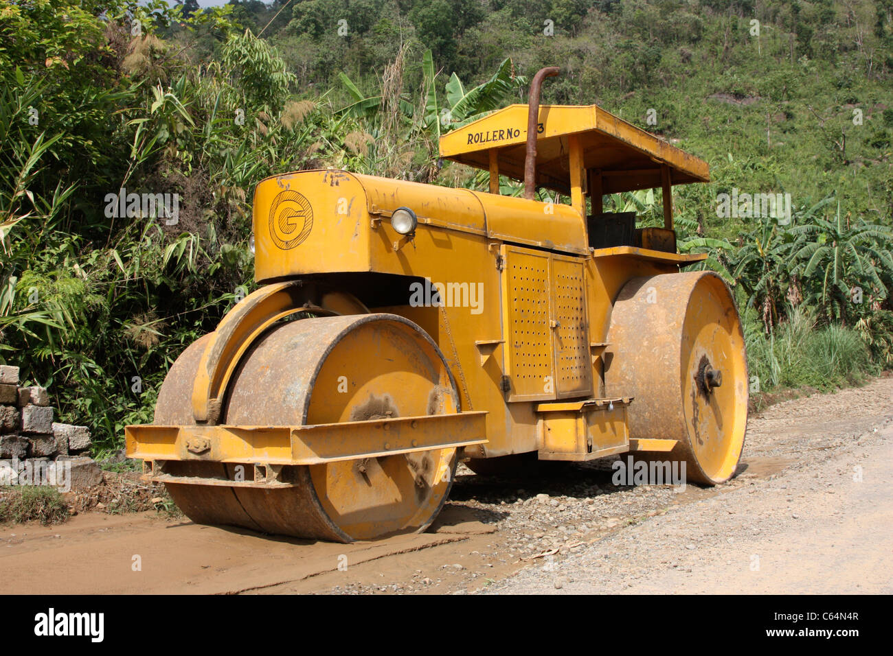 Road roller used in construction of the strategic mountain highway from Meghalaya to Manipur in north east India Stock Photo