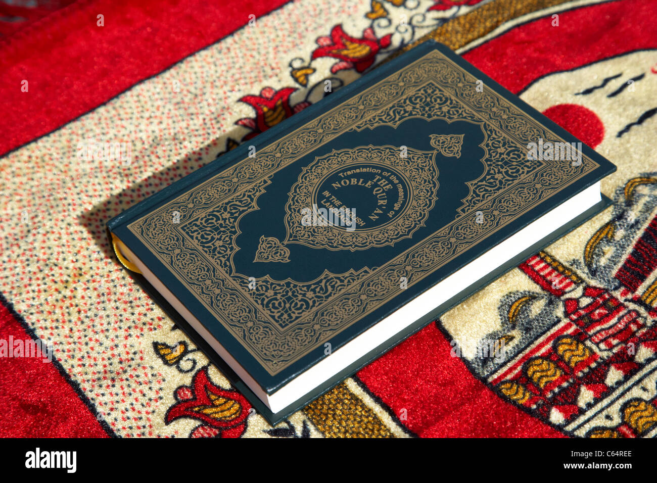 noble holy koran translated english version on a muslim prayer mat Stock Photo