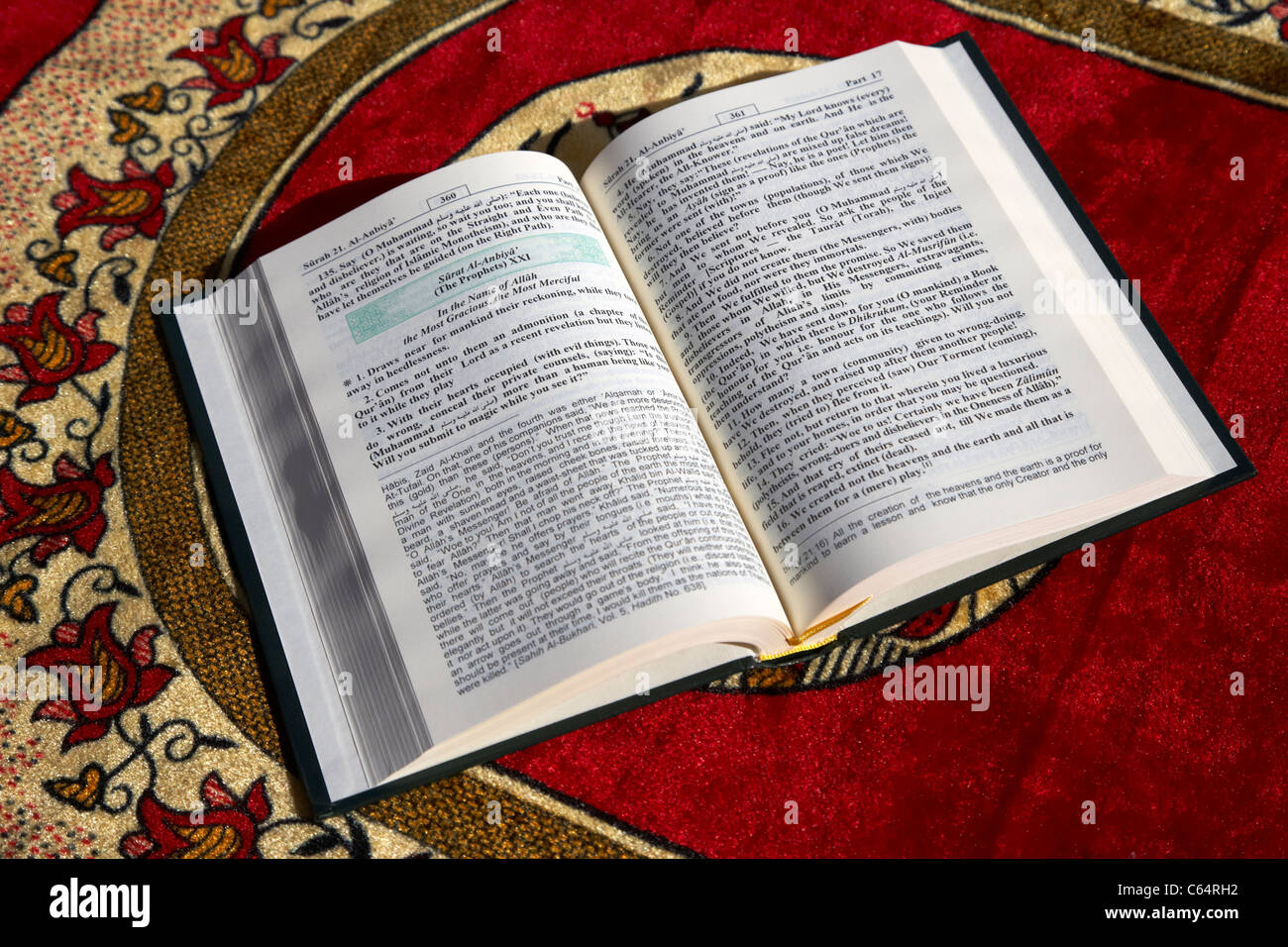 noble holy koran translated english version opened on a muslim prayer mat Stock Photo
